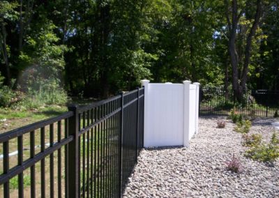 Starling style aluminum pool fence by OnGuard goes well with any of the Illusions Vinyl Fence styles and colors. The vinyl fence here hide the unsightly filter and works as a sound buffer.