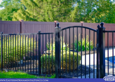 Eastern Ornamental Aluminum Style EO40V shown with a 4x4 Accent gate hung from available 4x4 posts with ball caps. Note the beautiful Grand Illusions Wood Grain privacy fence!