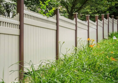 V3706 style - Stepped Victorian picet top by Illusions vinyl fence in Grand Illusions L102 Tan and posts in L106 Brown Grand Illusions colors.