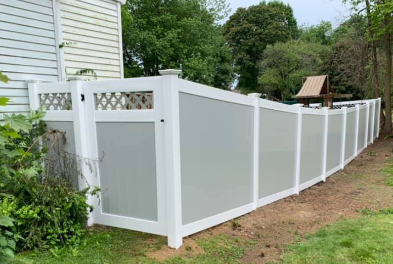 Illusions fence style V300-6. Straight top T&G privacy panel with classic white rails and classic gray boards. Gate is an Illusions style V3215D-6 gate with white frame and gray lattice and boards. Standard hardware is stainless steel powder coated available in white, black and hammered bronze.