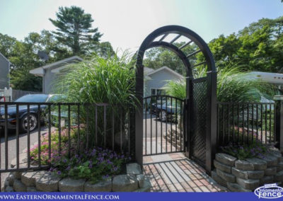 Eastern Aluminum Fence Style EO40V two rail, 48 inch tall BOCA pool code compliant fence. The accent gate is set in a Grand Illusions Arbor L-105 Black with small diagonal lattice side panels.