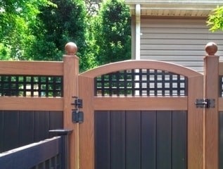 Rosewood and Black V3215SQ - Square lattice topped T&G privacy panels with matching crowned gate and ball caps on the posts.